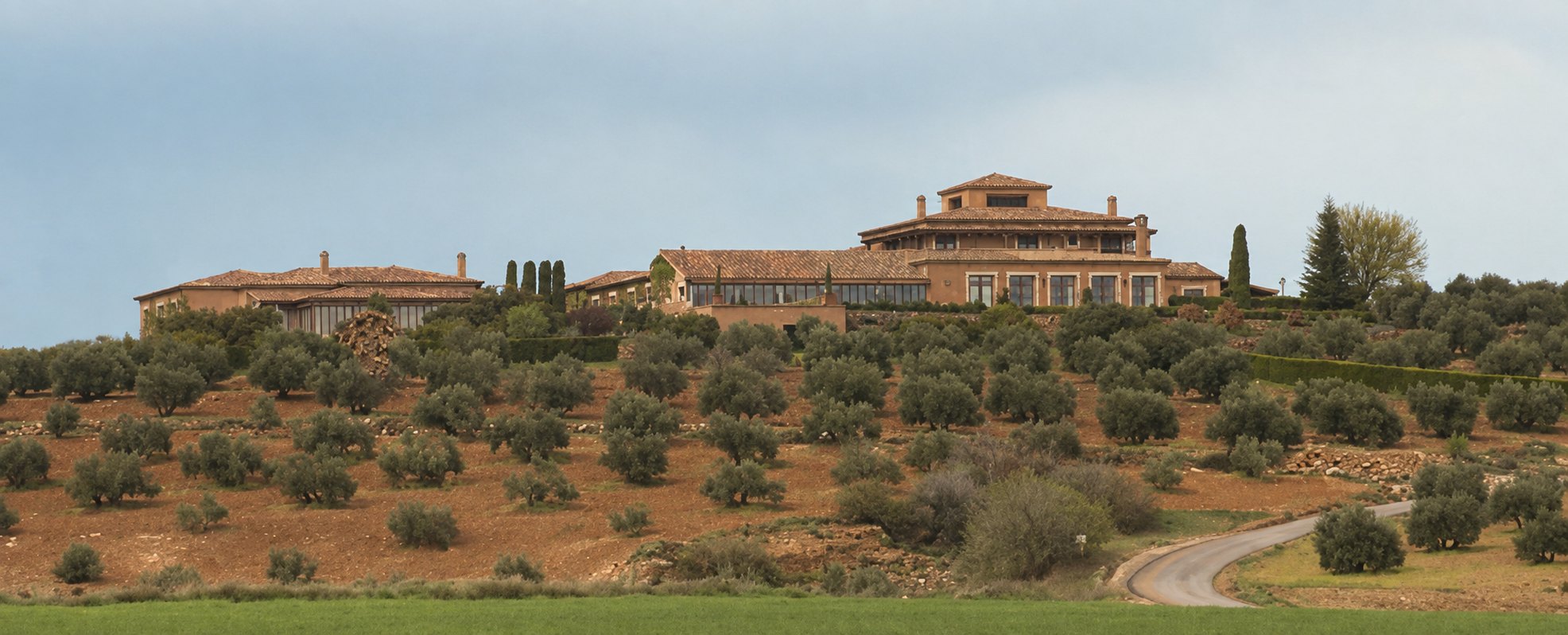 The lodge at El Crespo standing on a hilltop above terraced olive groves