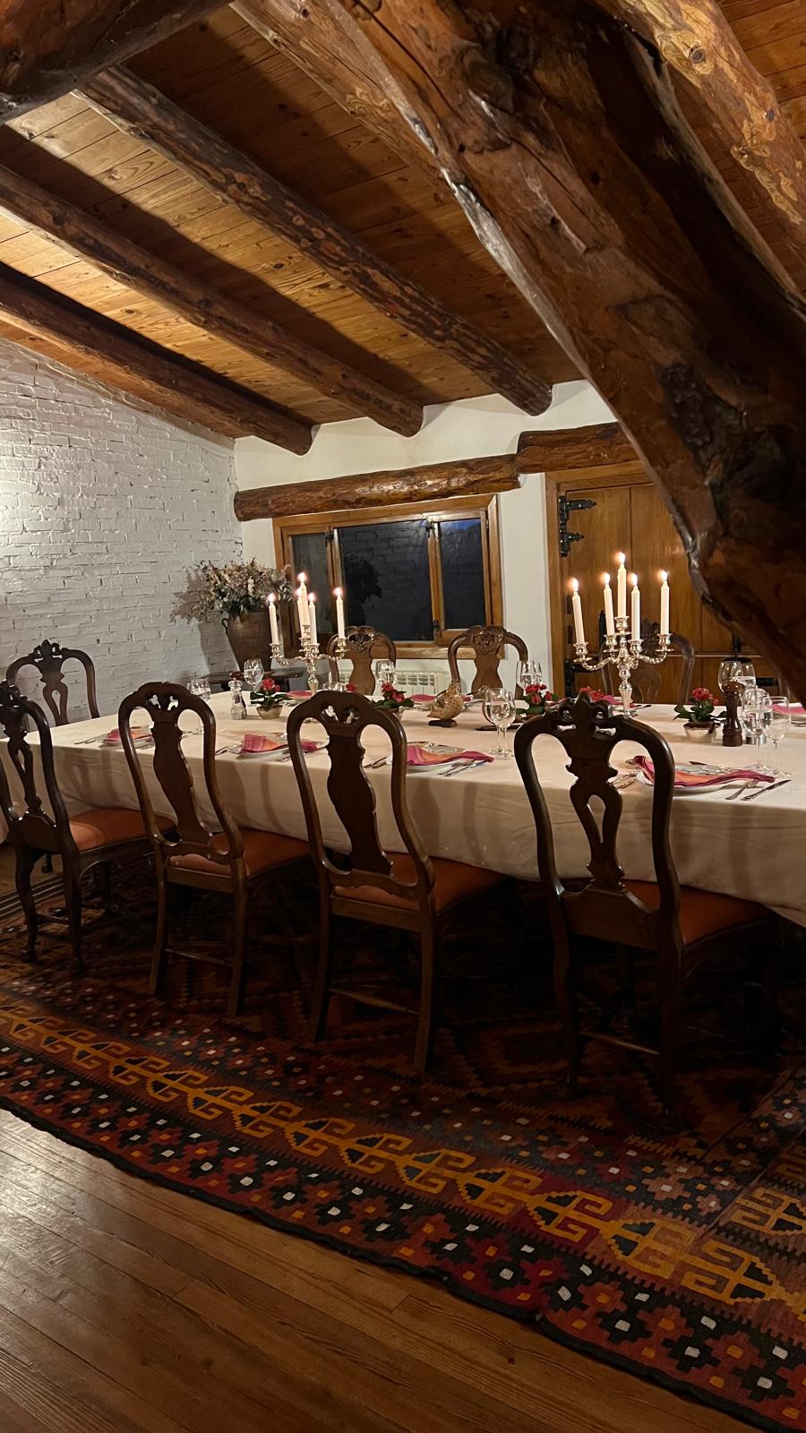Timber beams over the candlelit dining table at Fuentelfresno