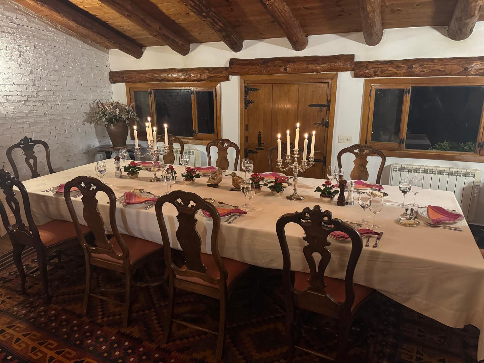 The dining room at Fuentelfresno laid for dinner by candlelight