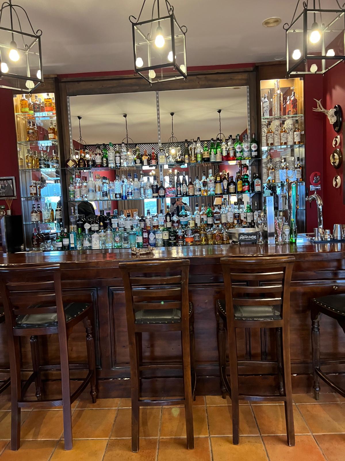 The mahogany lodge bar at La Cuesta stocked with malt whiskies and gins